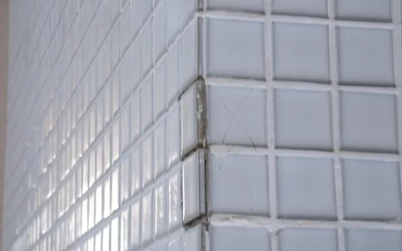 Parede de azulejos brancos em canto.