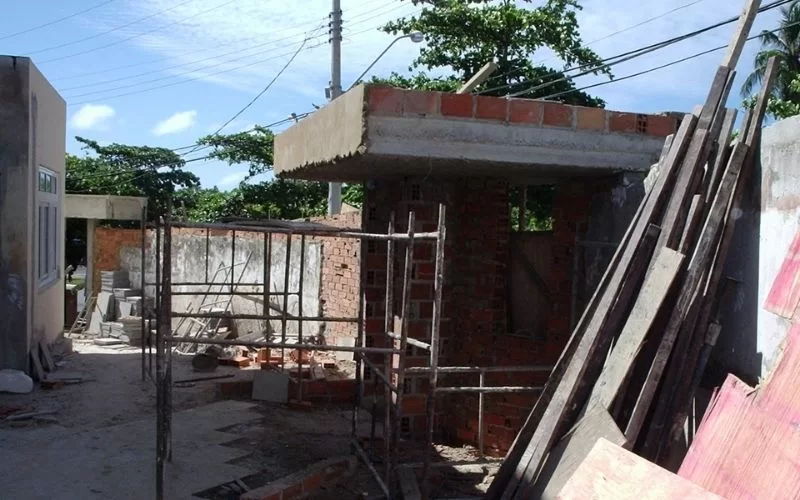 Construção de casa inacabada com andaimes.