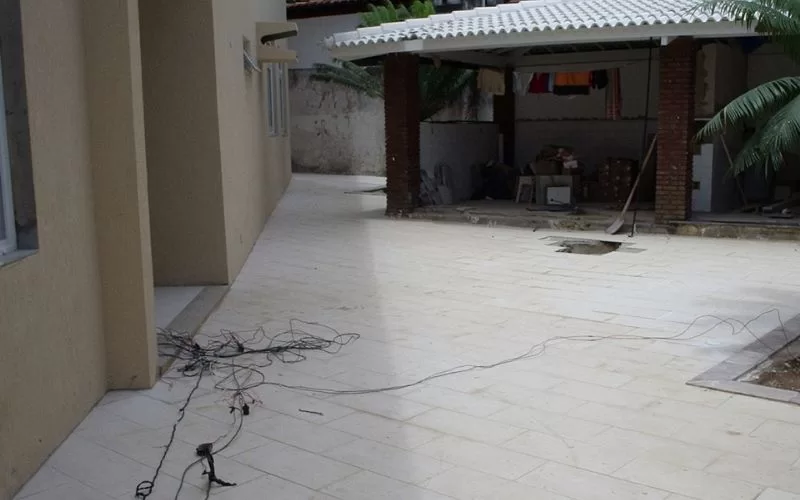 Quintal com fiação solta no chão.