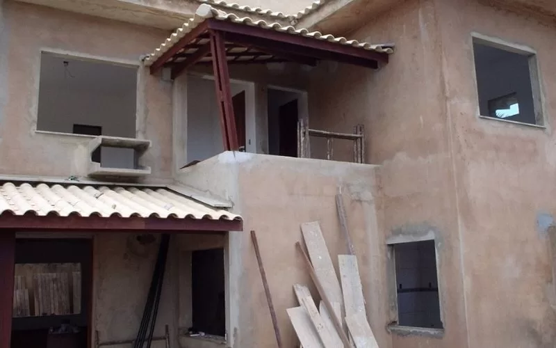 Casa em construção com telhado de cerâmica.