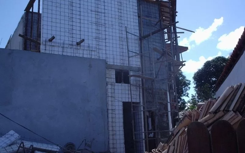 Fachada de edifício em construção com andaimes.