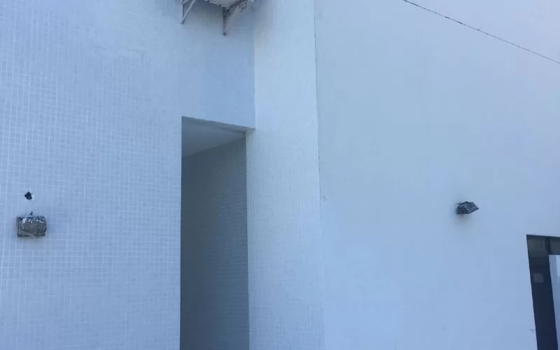 Parede exterior branca com paredes de azulejos.