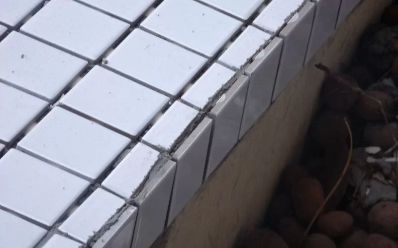 Azulejos brancos danificados numa parede