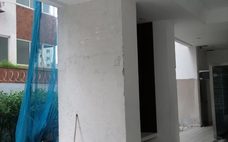 Área externa em construção com rede azul.