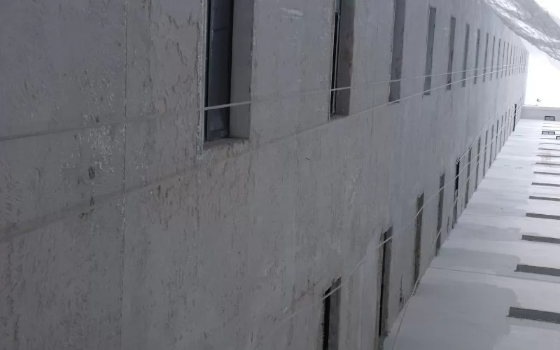 Fachada de edifício com várias janelas alinhadas.