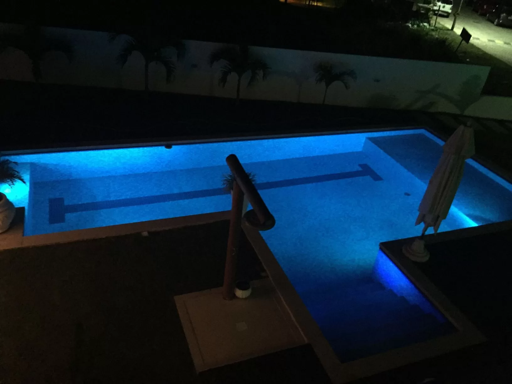 Piscina iluminada à noite, ângulo superior.