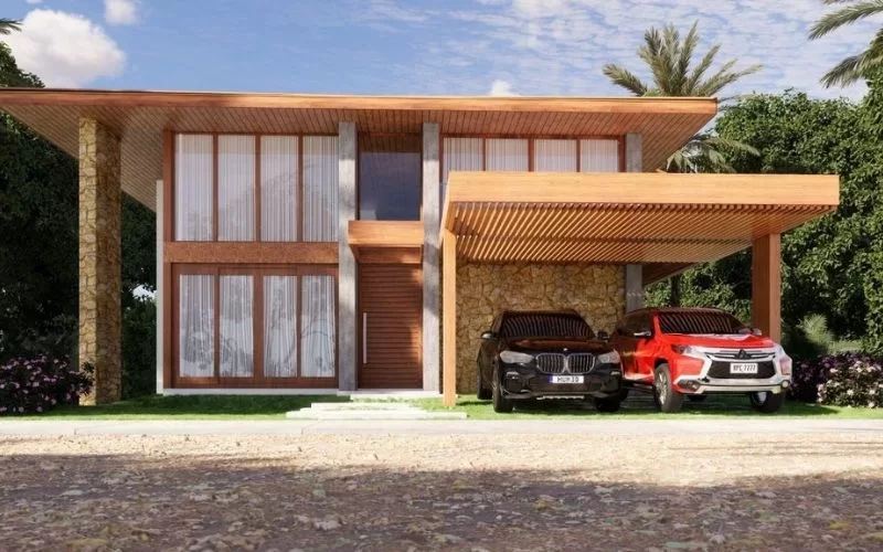 Casa moderna com dois carros estacionados.