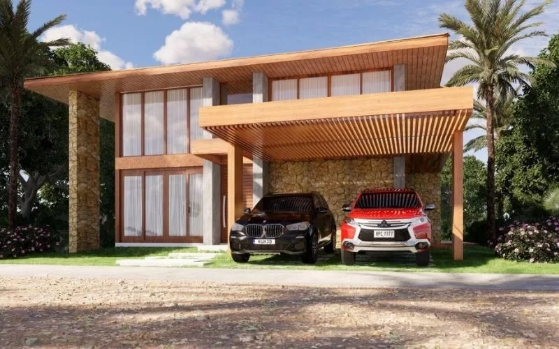Casa moderna com carros na garagem ao sol.