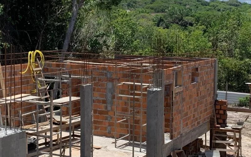 Construção de casa em tijolos com moldura metálica.