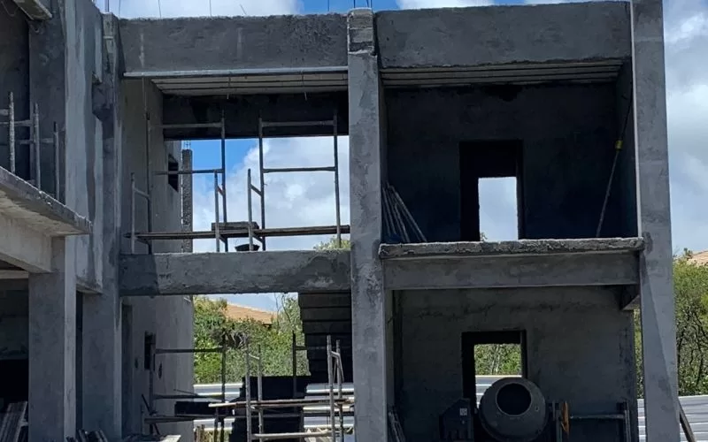 Edifício em construção com andaimes visíveis.