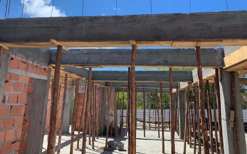 Obras de construção com vigas e pilares de madeira.