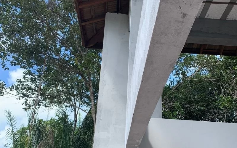 Estrutura de concreto com árvores ao fundo.